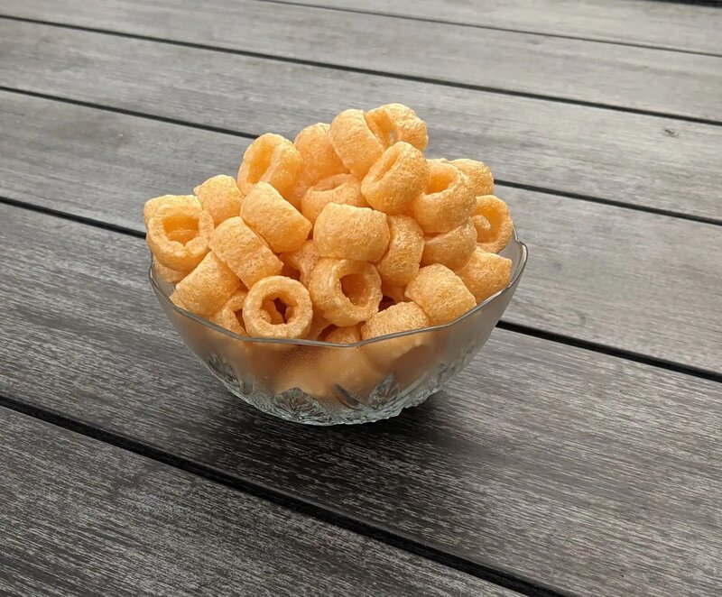 Bowl of fried Swirly's Original Fryums on a wooden table